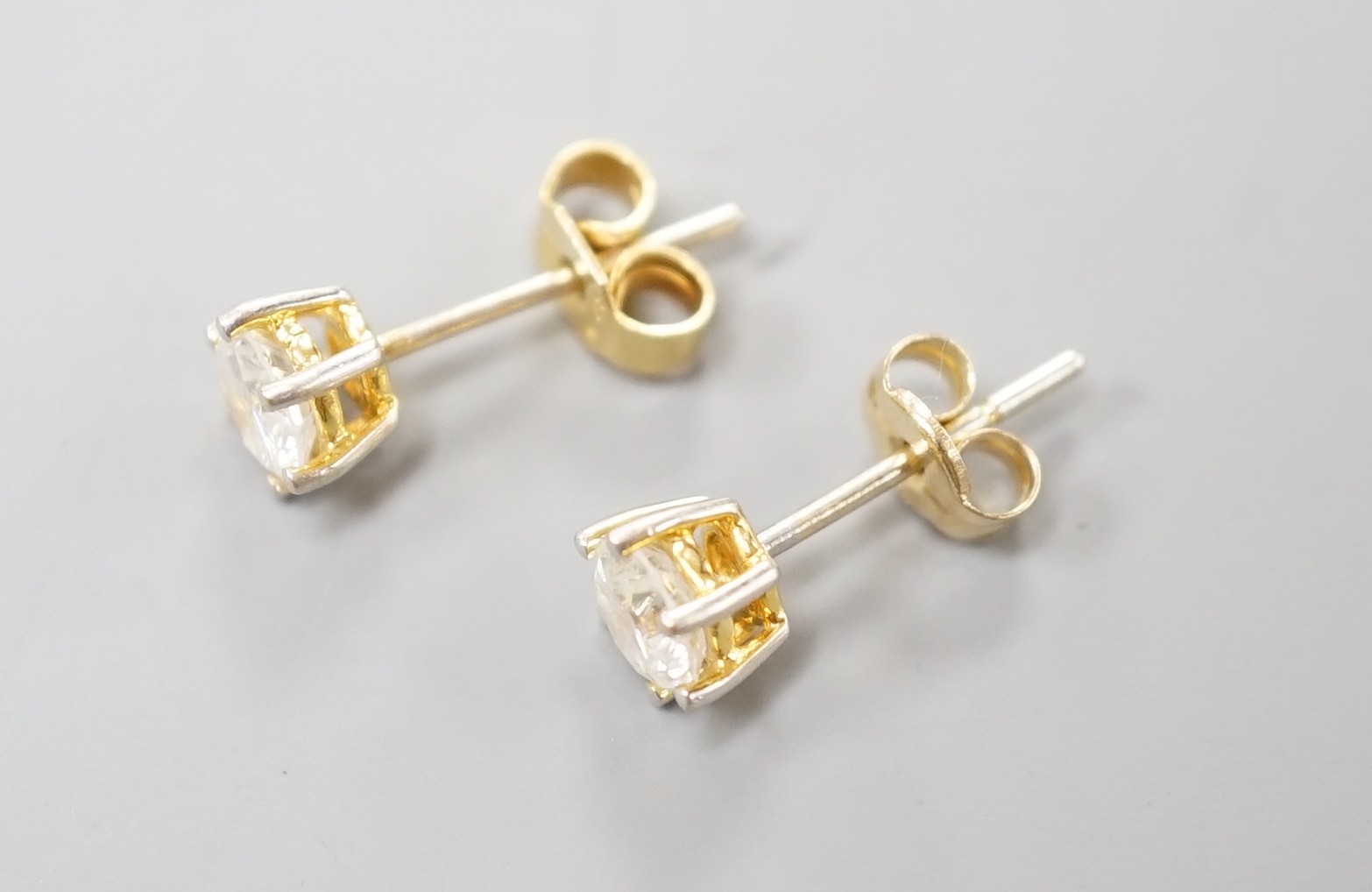 A pair of yellow metal and solitaire diamond set ear studs, gross weight 1.2 grams, each stone weighing approx. 0.33ct.